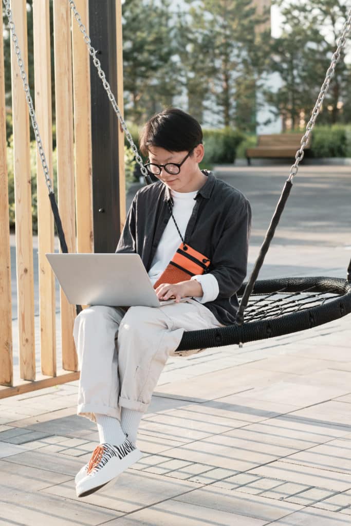 Freelancer using laptop outdoors 1216290 scaled
